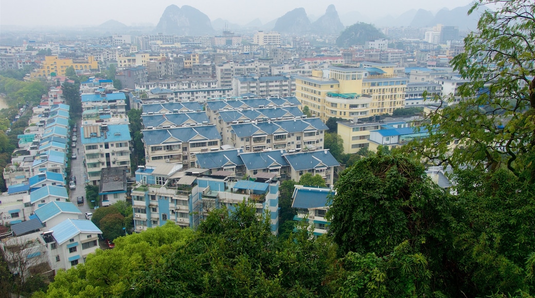 Elephant Trunk Hill which includes landscape views, a city and mist or fog