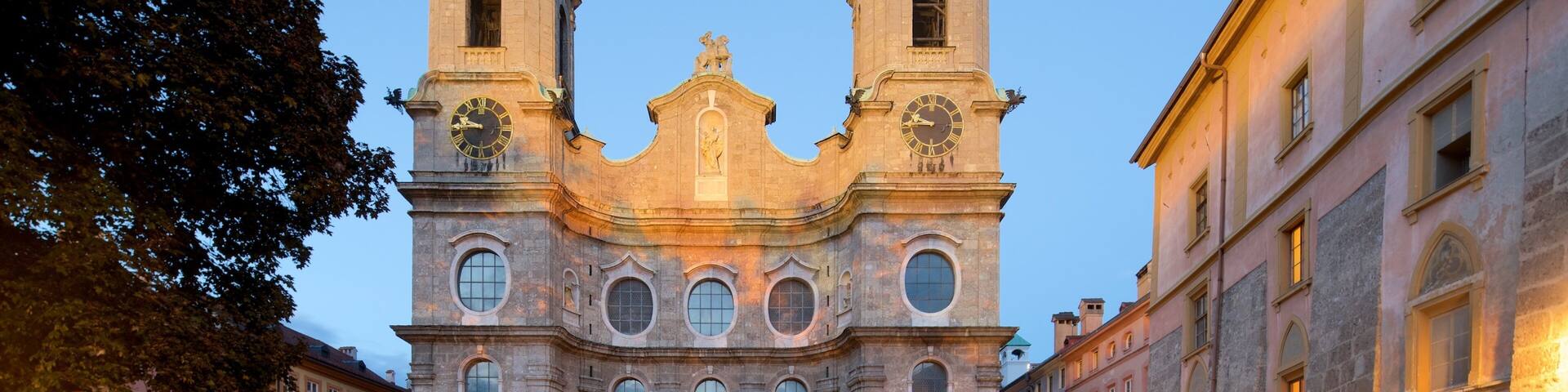 A historic church with two towers and a central dome, surrounded by cobblestone streets and traditional buildings.