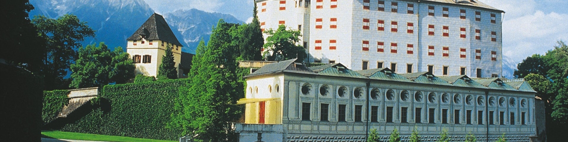 Ambras Castle showing chateau or palace, heritage architecture and a garden