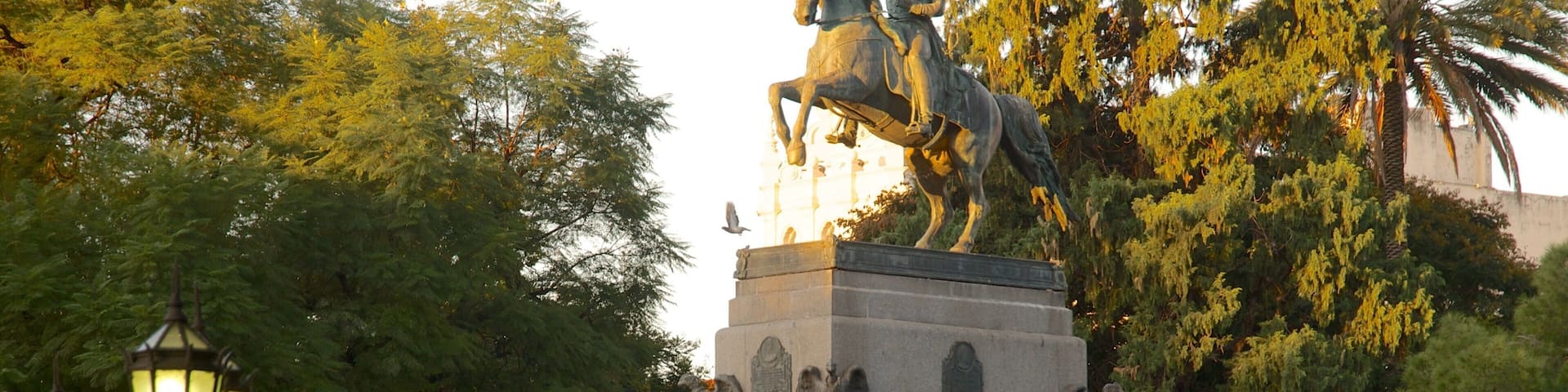 Plaza San Martin showing a sunset and a statue or sculpture