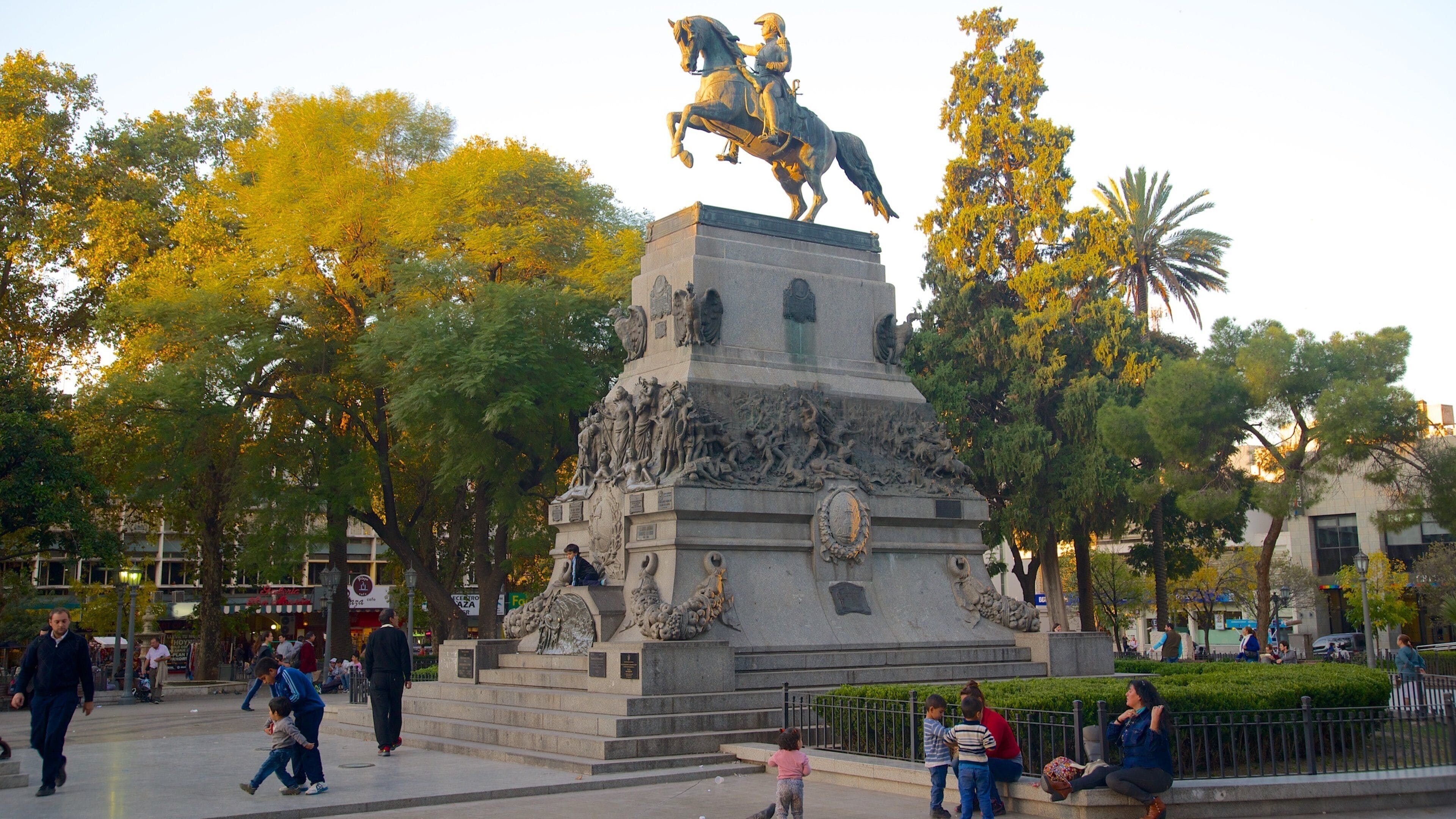 Plaza San Martin showing a statue or sculpture, a sunset and a park