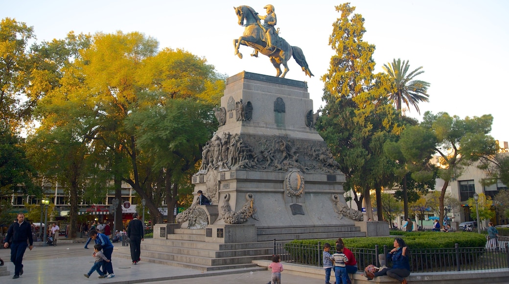 Plaza San Martin showing a statue or sculpture, a sunset and a park