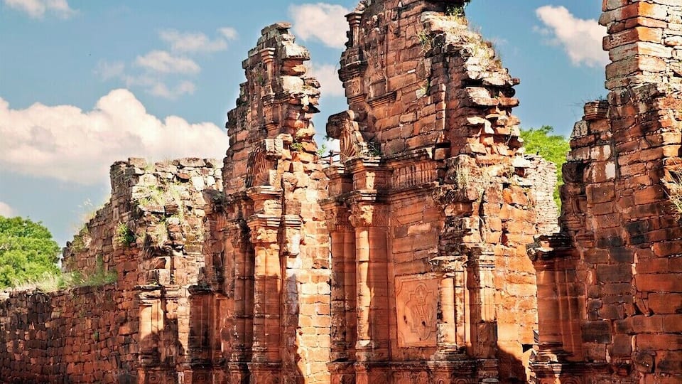 Ancient brick ruins with columns and intricate carvings.