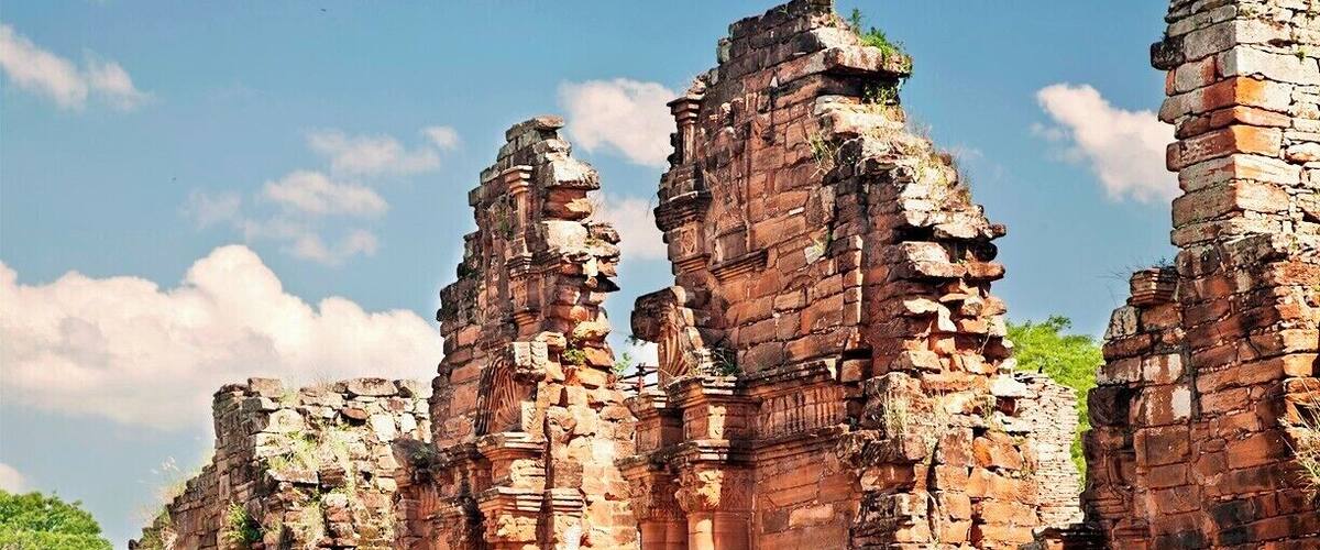 Ancient brick ruins with columns and intricate carvings.