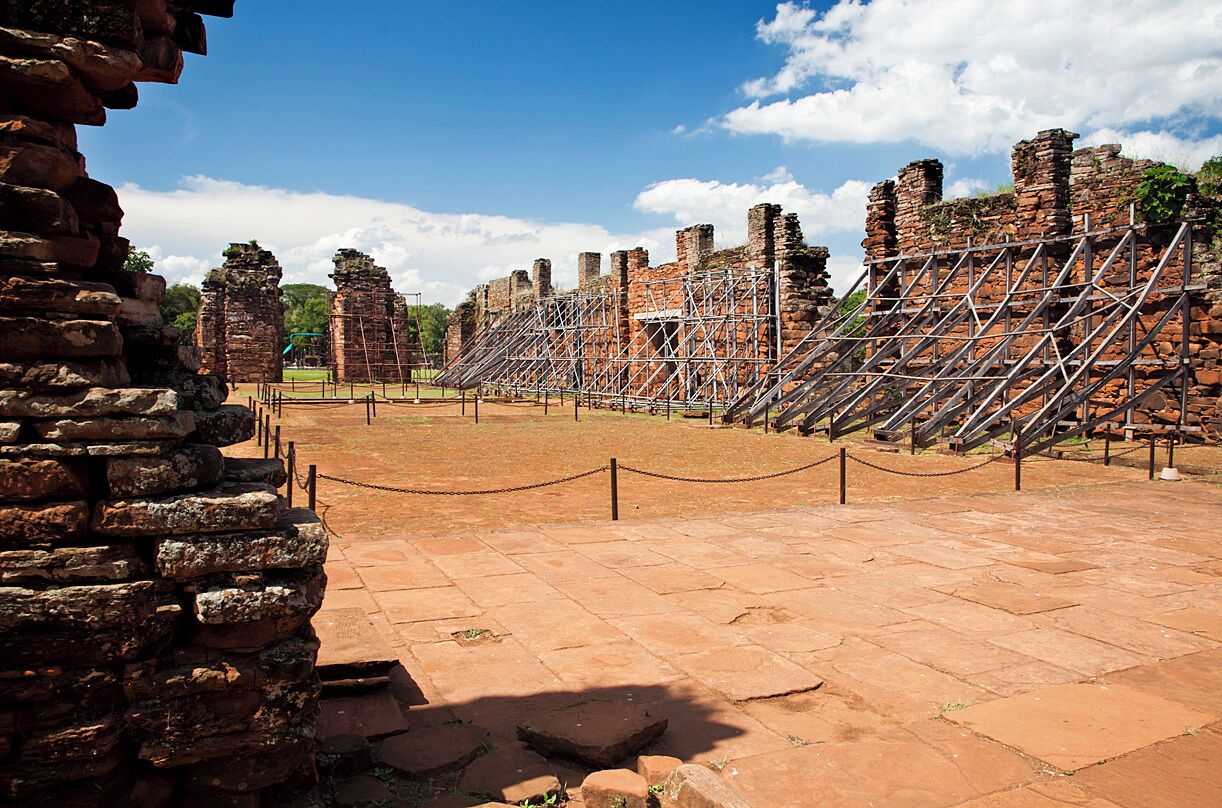 The red sandstone remains of the church at this 350 year old Jesuit mission are impressive. It once stood 30ft tall (10m) and covered an area 240ft long and 79ft wide (74m x 24m). Although none of the woodwork remains, some of the original floor tiles are still in place.
San Ignacio Mini was a Jesuit mission established in 1610 with the aim of converting the local Guaraní natives. The mission moved to this location in 1666 and a large complex was erected to house and protect up to 4000 converts. The complex was built in Spanish baroque style around a central courtyard and included a large church, school, hospital, cemetery, dormitories and workshops.
The mission was largely abandoned when the Jesuits were expelled by Spanish decree in 1767, and was then destroyed by Paraguayan decree some 50 years later. The remains of the mission were rediscovered in 1897 and are now listed as a UNESCO World Heritage Site.