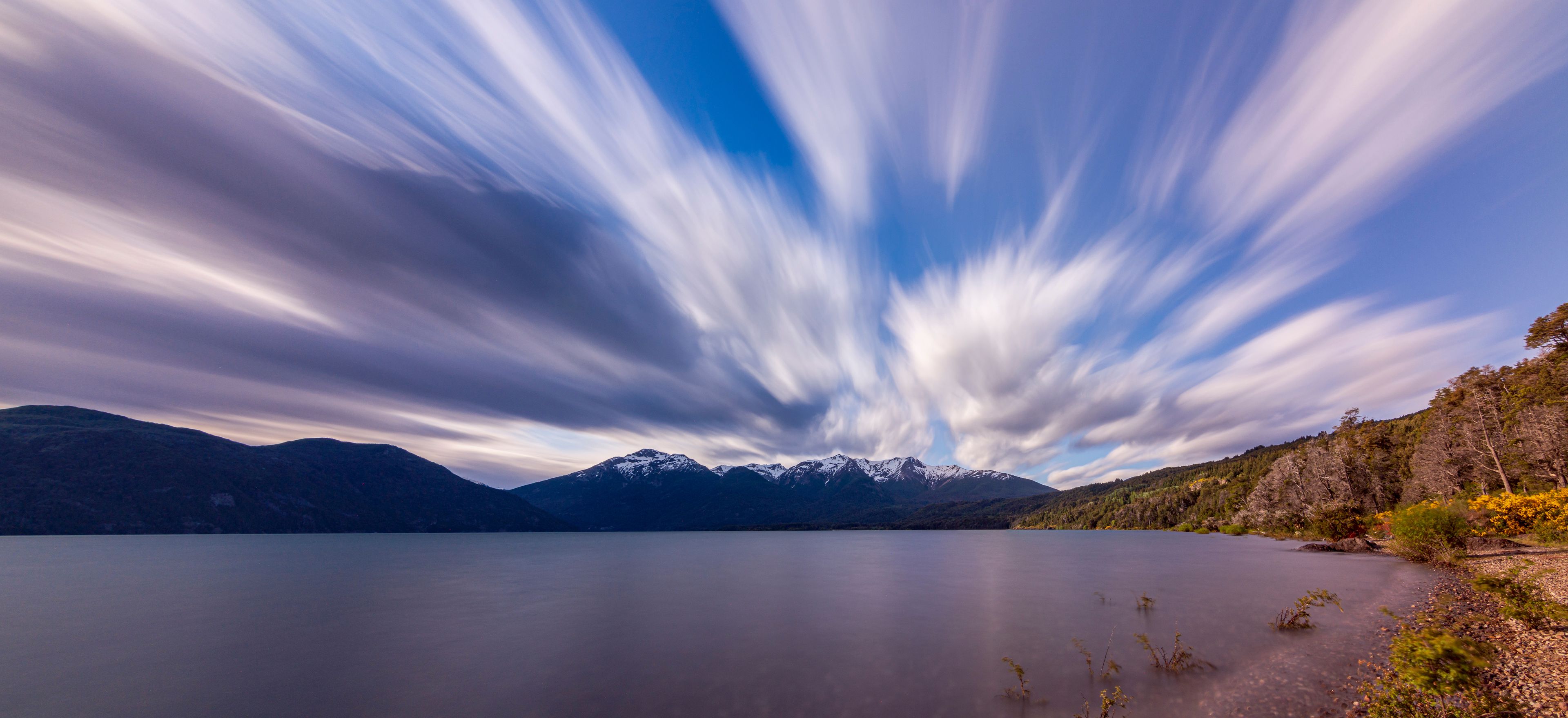 Long exposure shot during windy day in Futalaufquen lake against snow-capped Andes mountains, Los Alerces National Park, Patagonia, Argentina