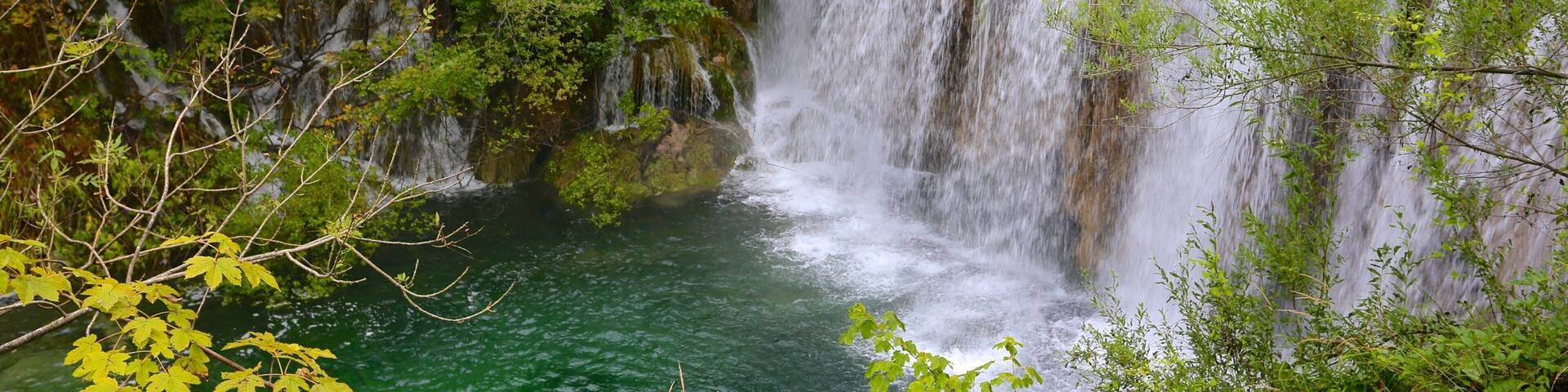 Plitvice Lakes National Park - Entrance 1 featuring a cascade and a lake or waterhole