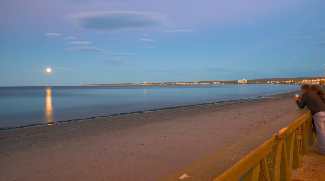 Puerto Madryn Beach which includes general coastal views, a sunset and a sandy beach