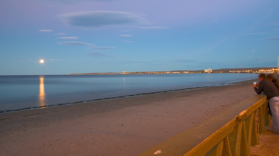 Puerto Madryn Beach which includes general coastal views, a sunset and a sandy beach