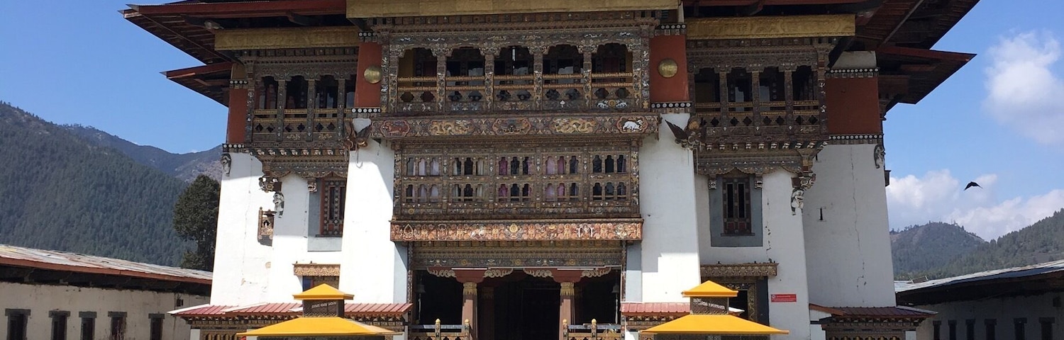 A traditional Tibetan building with ornate architecture and a clear blue sky.