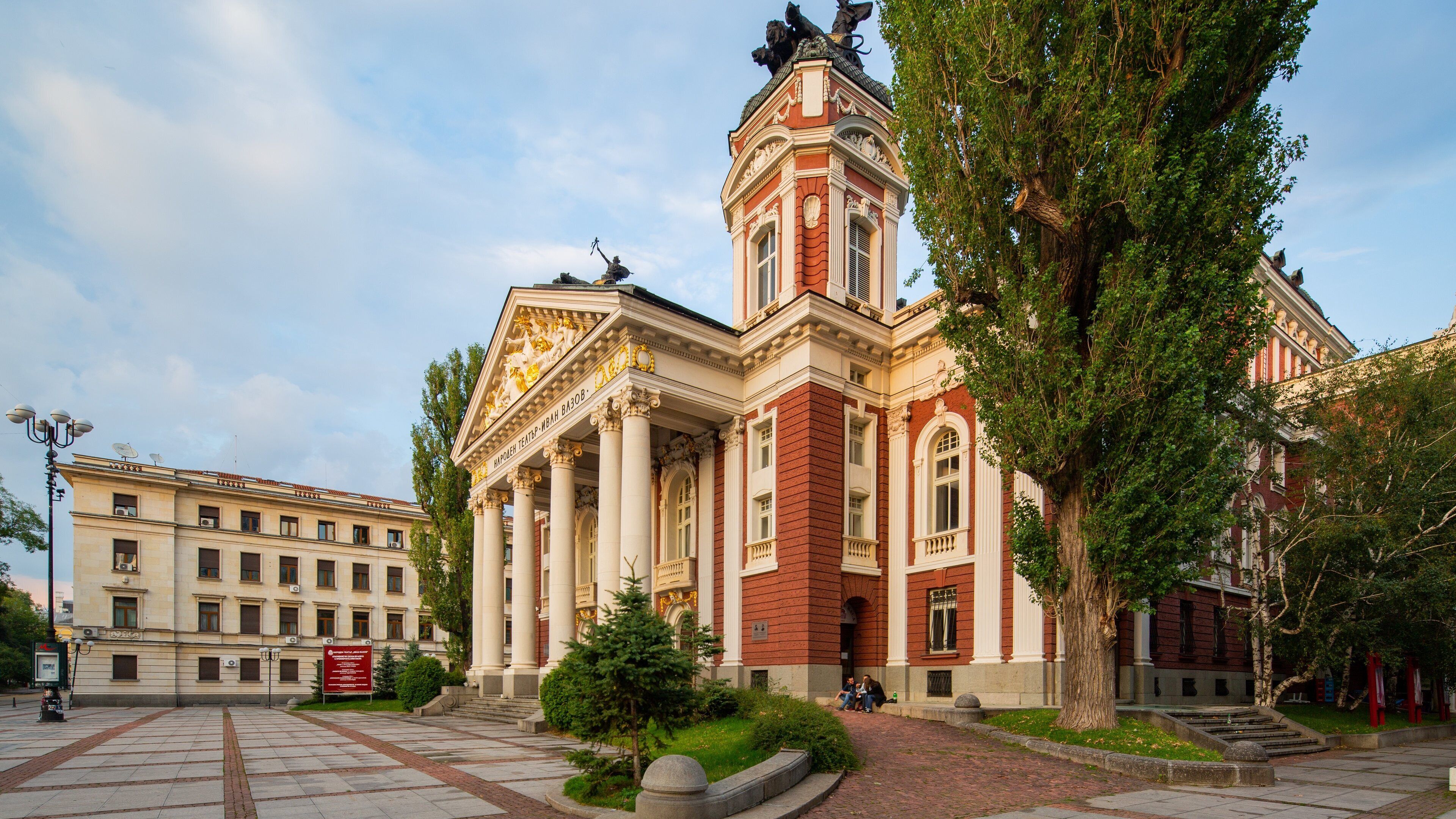 A grand building with classical architecture, featuring columns and a prominent tower.