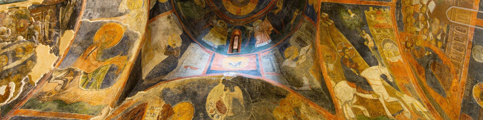 A detailed mosaic ceiling with religious iconography and geometric patterns.