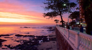 Farol da Barra Beach which includes general coastal views, a sunset and a coastal town