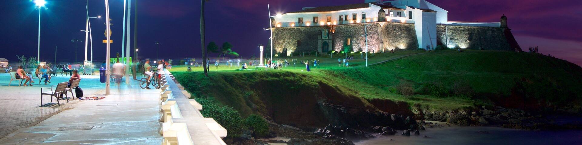 Farol da Barra Beach featuring a lighthouse, night scenes and general coastal views