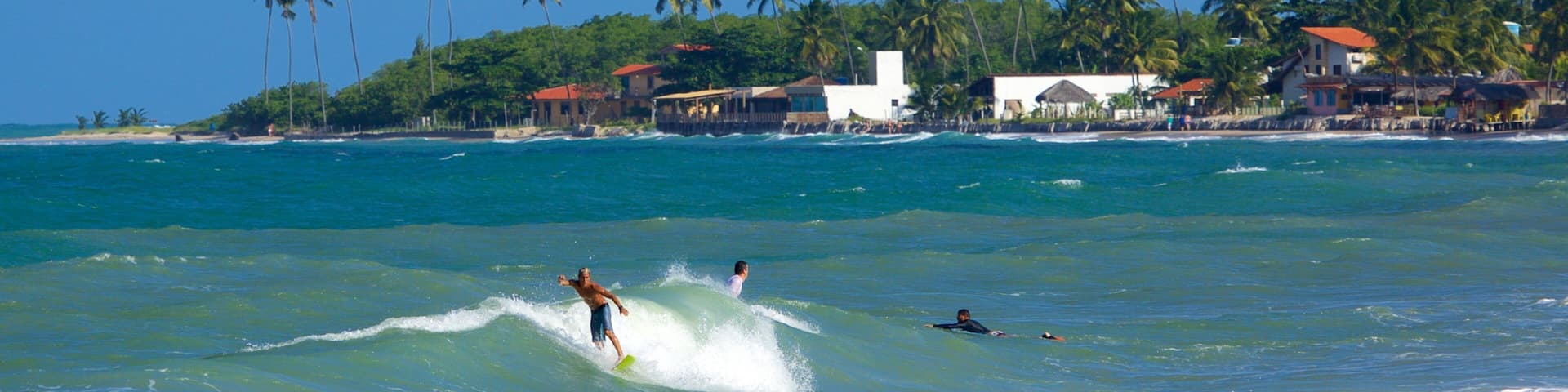 Maracaipe Beach showing surf, tropical scenes and a coastal town