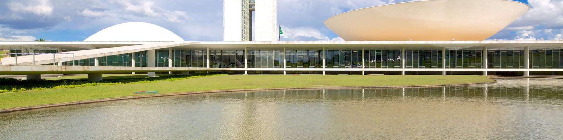 A modern building with a large white dome and a tall tower.