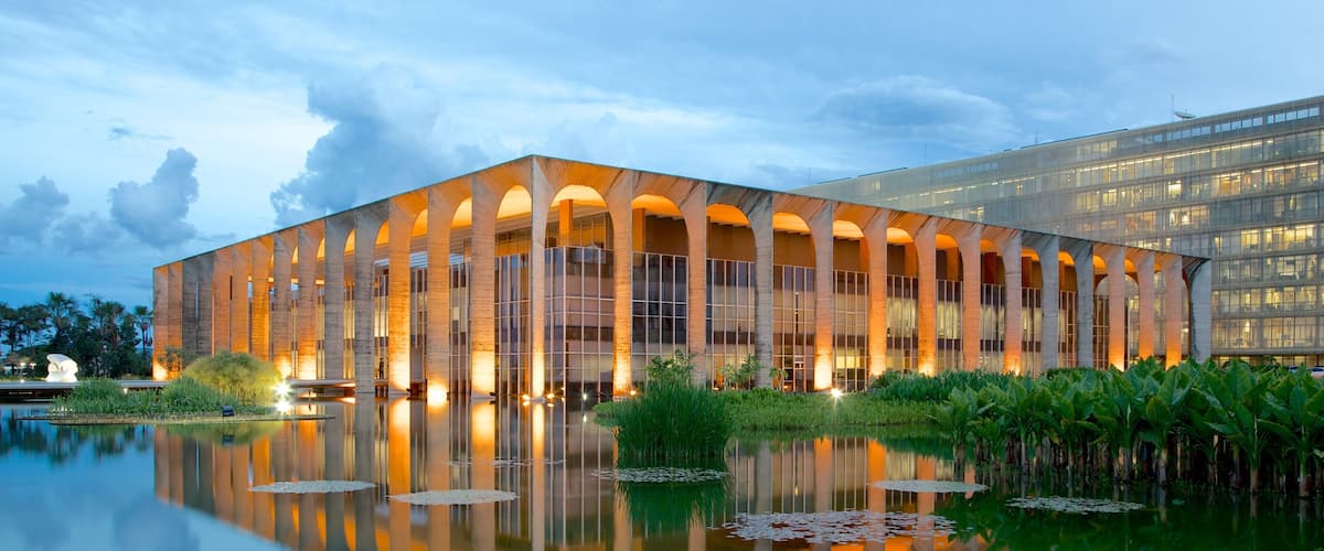 Itamaraty Palace which includes modern architecture, a lake or waterhole and a castle