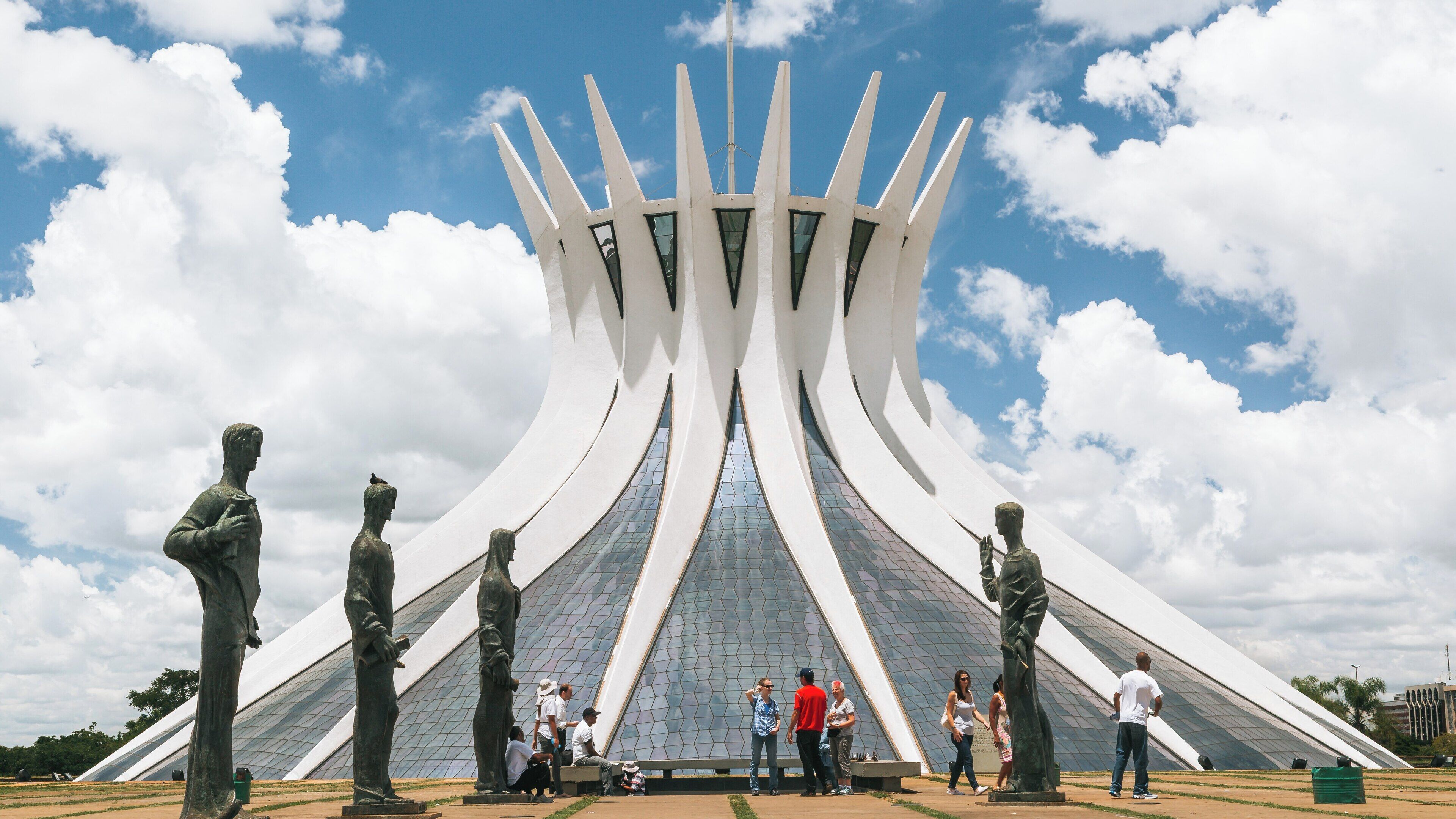 Metropolitan Cathedral showcases modern architecture in Asa Sul, Brasília, under a bright blue sky filled with clouds
