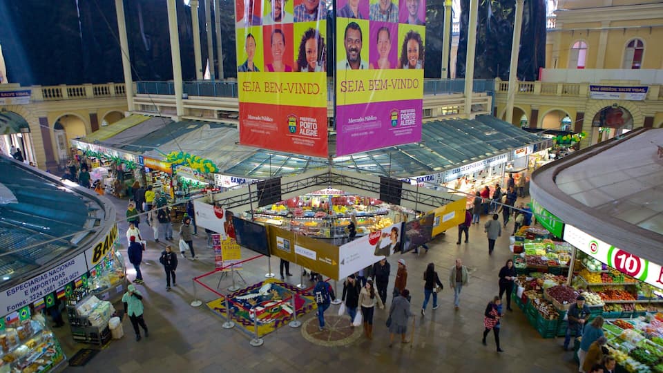 A bustling indoor market with various stalls and a central display area.