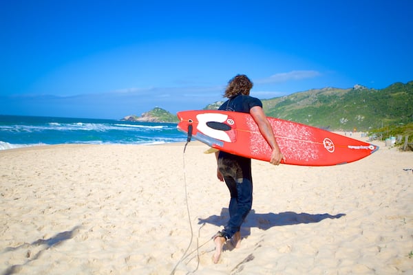 Mole Beach showing surfing and a beach as well as an individual male