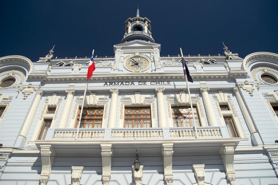 The facade of the Armada de Chile building with ornate columns and a clock.