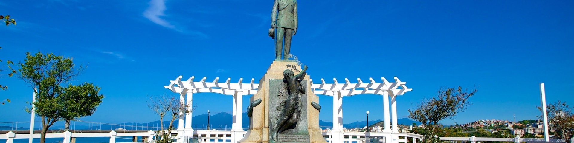 Hercilio Luz Bridge featuring a statue or sculpture and a garden