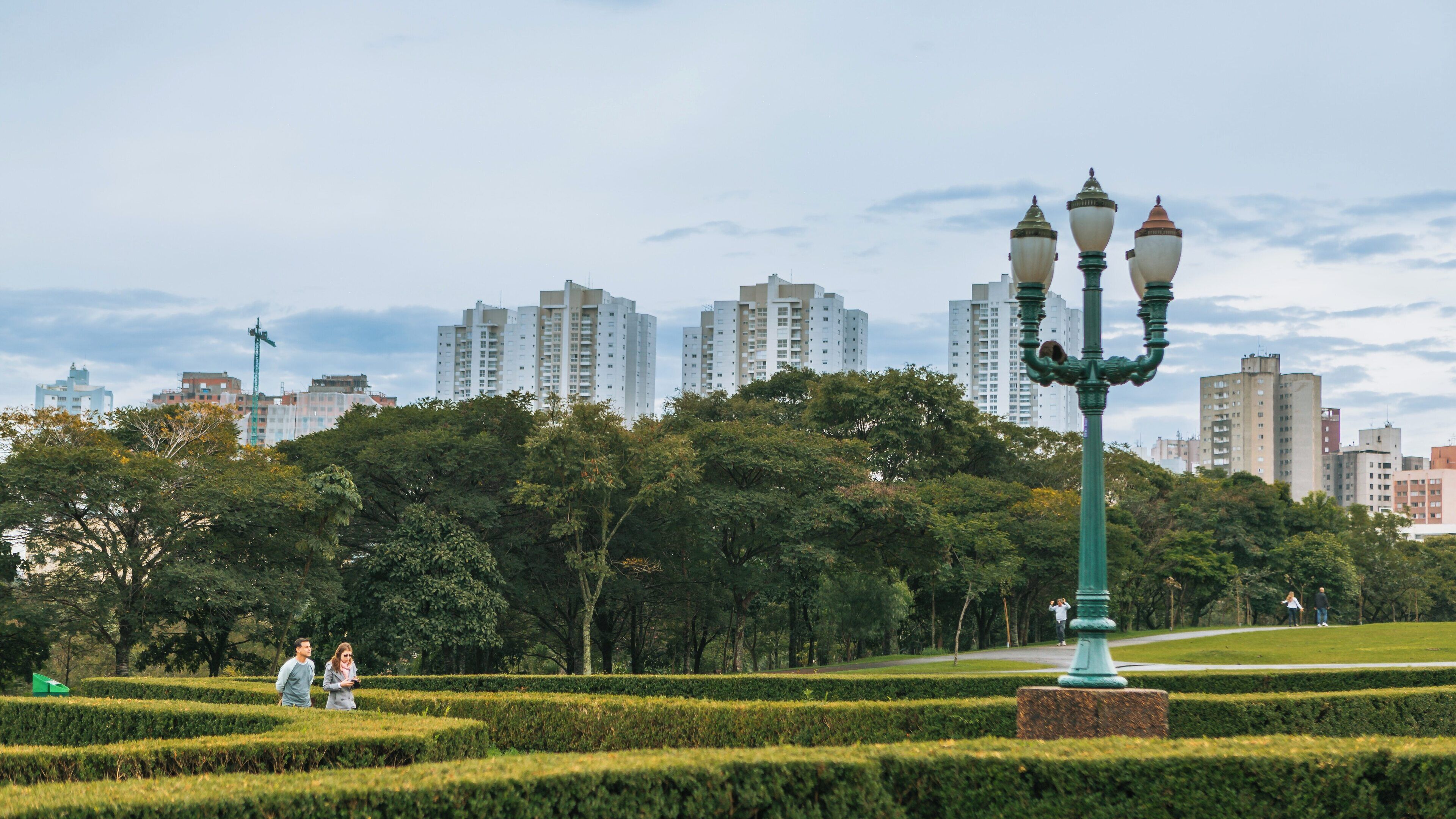 Exploring the beauty of Botanical Garden of Curitiba in Matriz, Curitiba, Paraná, Brazil with lush greenery and urban skyline in the background