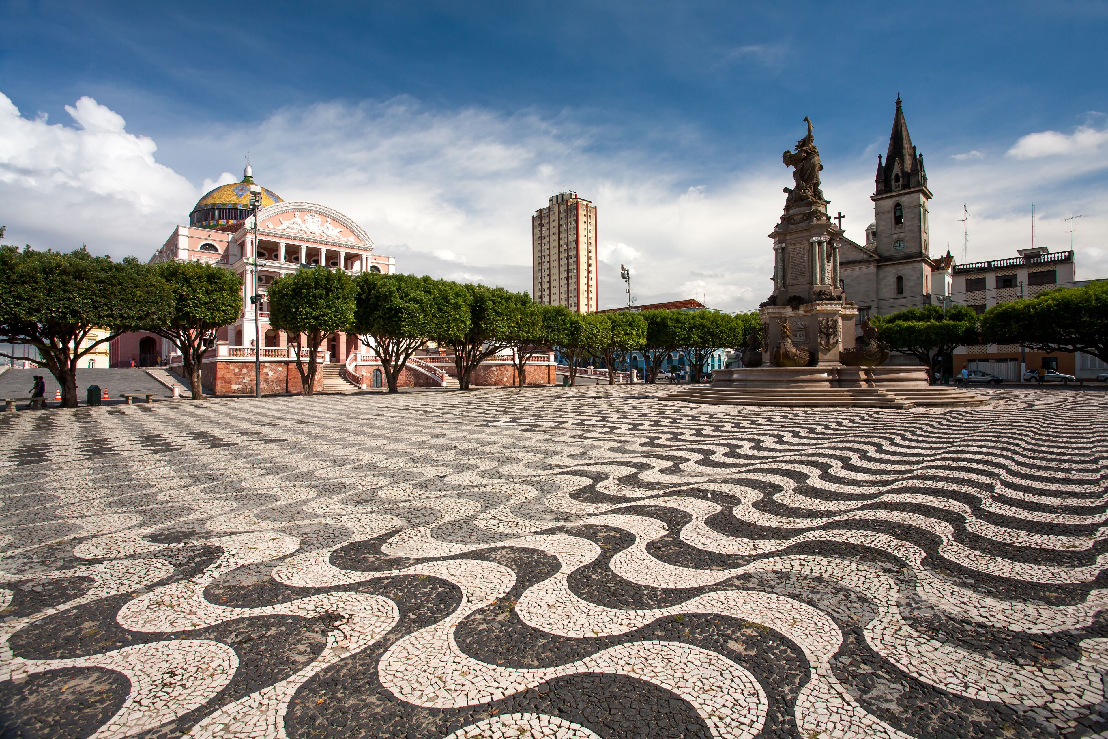 Manaus city sidewalk with Amazon theatre and church
