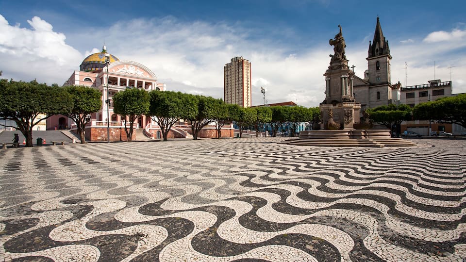 Manaus city sidewalk with Amazon theatre and church
