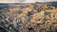 Aerial Drone Fly Above La Paz, Bolivia, Crowder Metropolitan City, Houses, Skyscrapers and Andean Cordillera Mountain Range in the Background