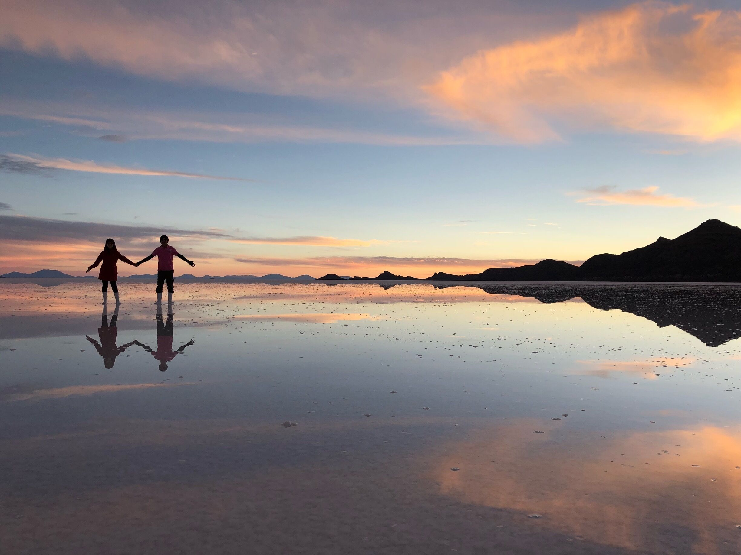 Enjoying sunset and the perfect reflection in Uyuni salt flat 