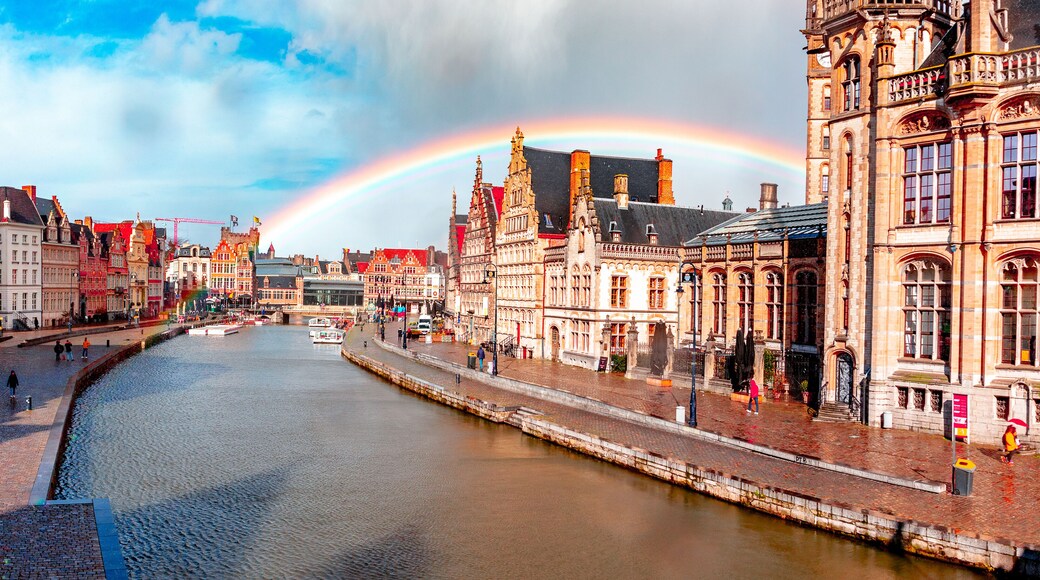 Ghent, Belgium, at sunset in spring with a rainbow. Historic city where you can see both Korenlei and Graslei as the river Lys (Leie) passes through the middle. Common place for tourists and students.