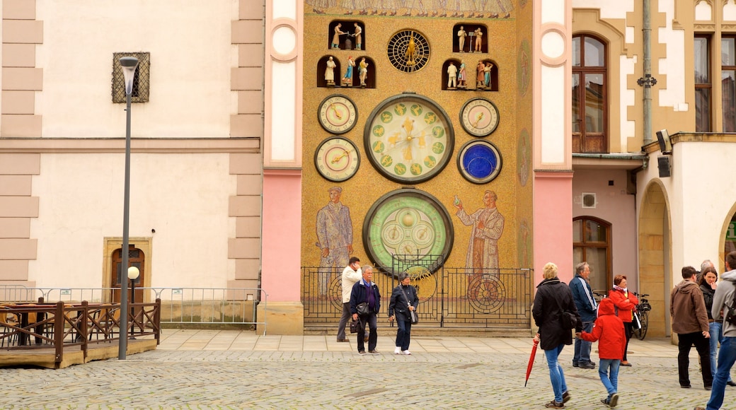 Astronomical Clock featuring heritage elements and a city as well as a small group of people