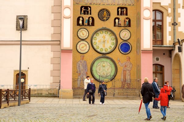 Astronomisk klocka som inkluderar en stad och historiska element sÄvÀl som en liten grupp av mÀnniskor