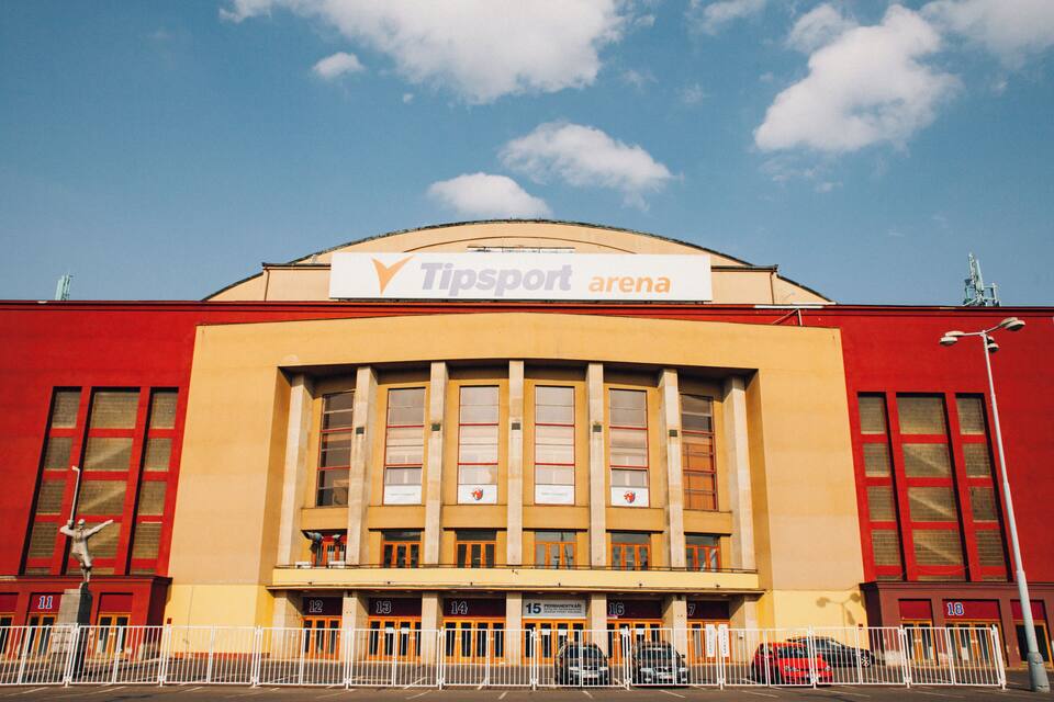 A Tipsport arena with a red facade and multiple windows.