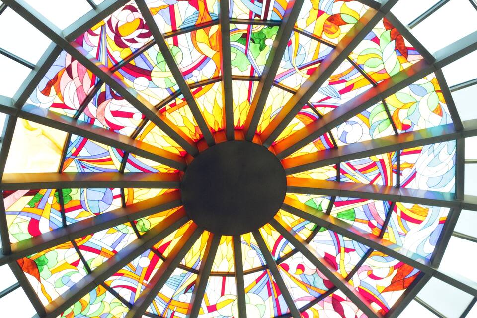 A colorful stained glass window with geometric patterns.
