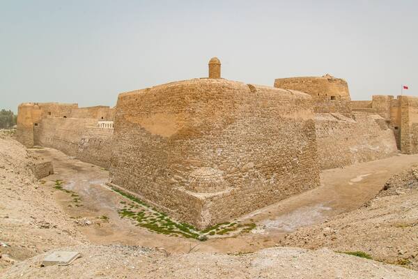 A large, ancient stone fortress with a central dome and surrounding walls.