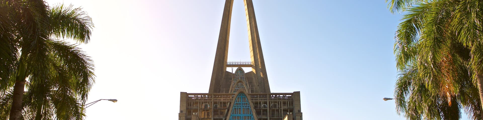 A large church with a tall, pointed arch and a blue stained glass window.