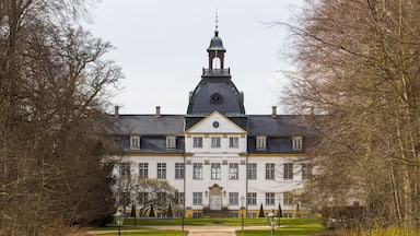 A large, historic building with a prominent tower and a symmetrical facade.