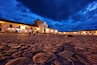 Low wide-angle photo of Villa de Leyva Plaza taken at dusk toward the church
