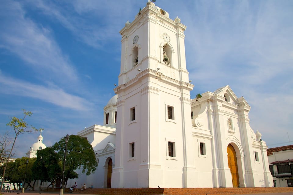 A white church with a bell tower and a dome.
