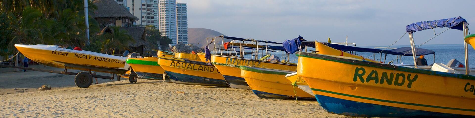 Rodadero Beach showing a sandy beach, a coastal town and boating