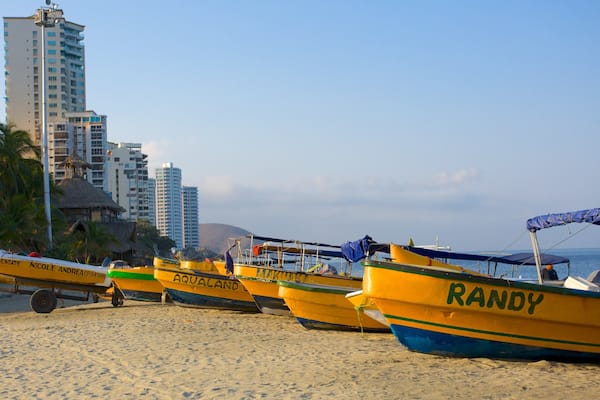 Rodadero Beach showing a sandy beach, a coastal town and boating