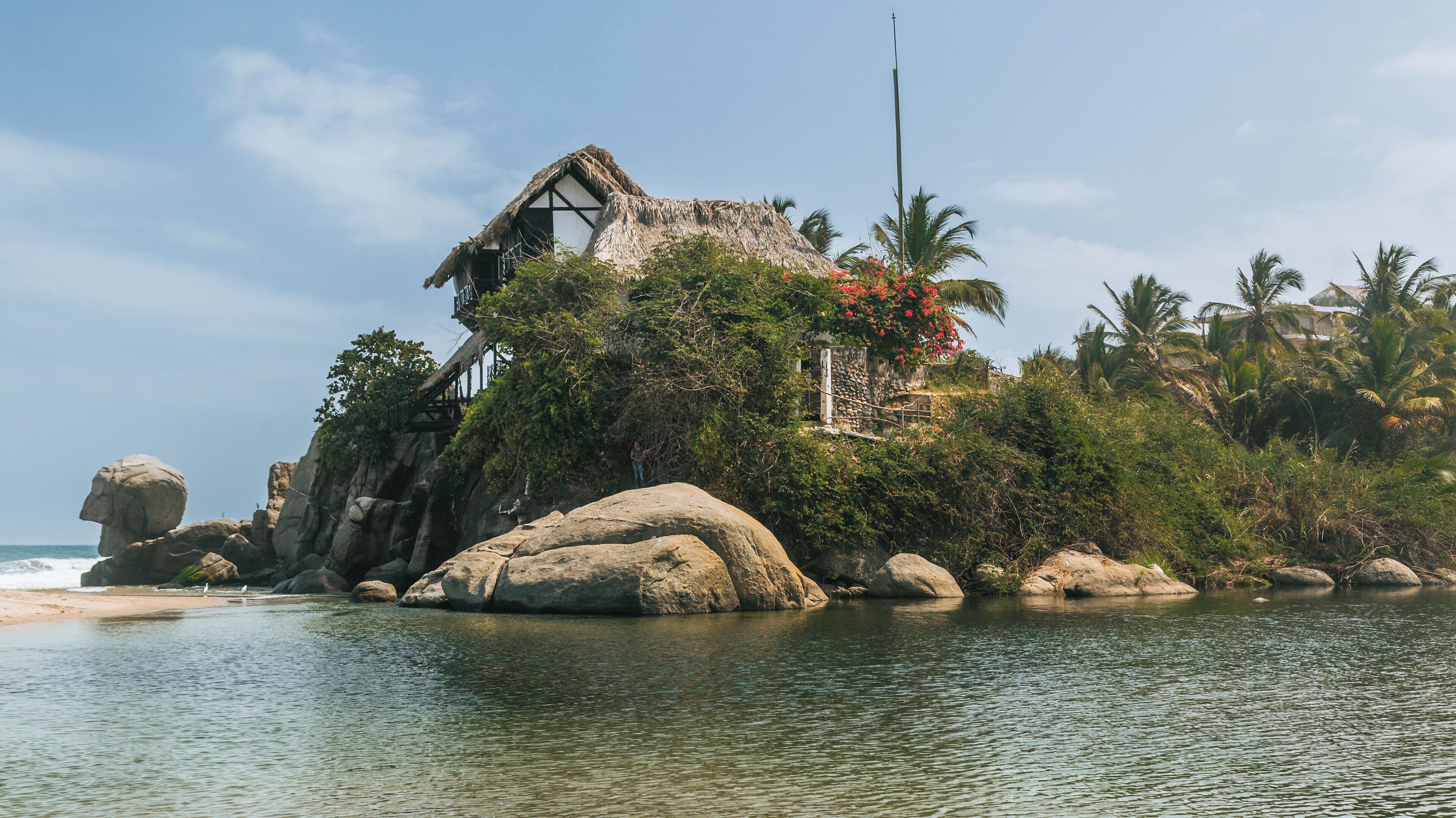 Exploring the tranquil beauty of Tayrona National Natural Park at Villa Concha in Colombia under a bright blue sky
