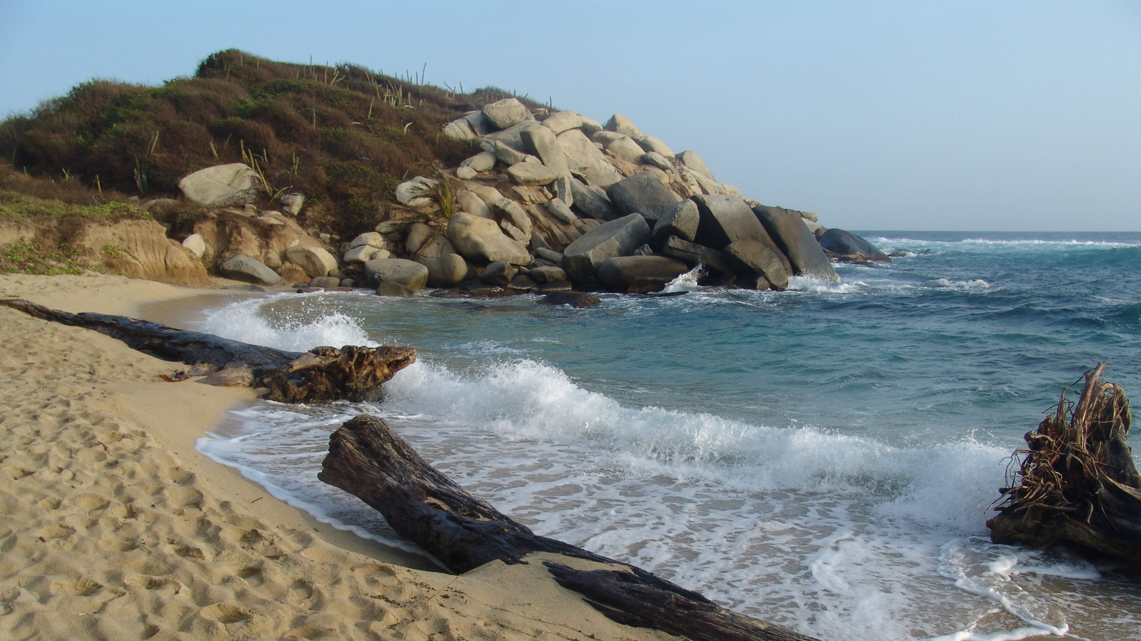 Tayrona National Natural Park featuring a beach, rocky coastline and general coastal views