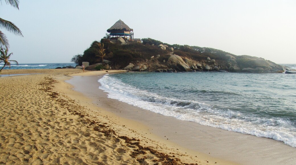 Tayrona National Natural Park showing a beach, general coastal views and a sunset