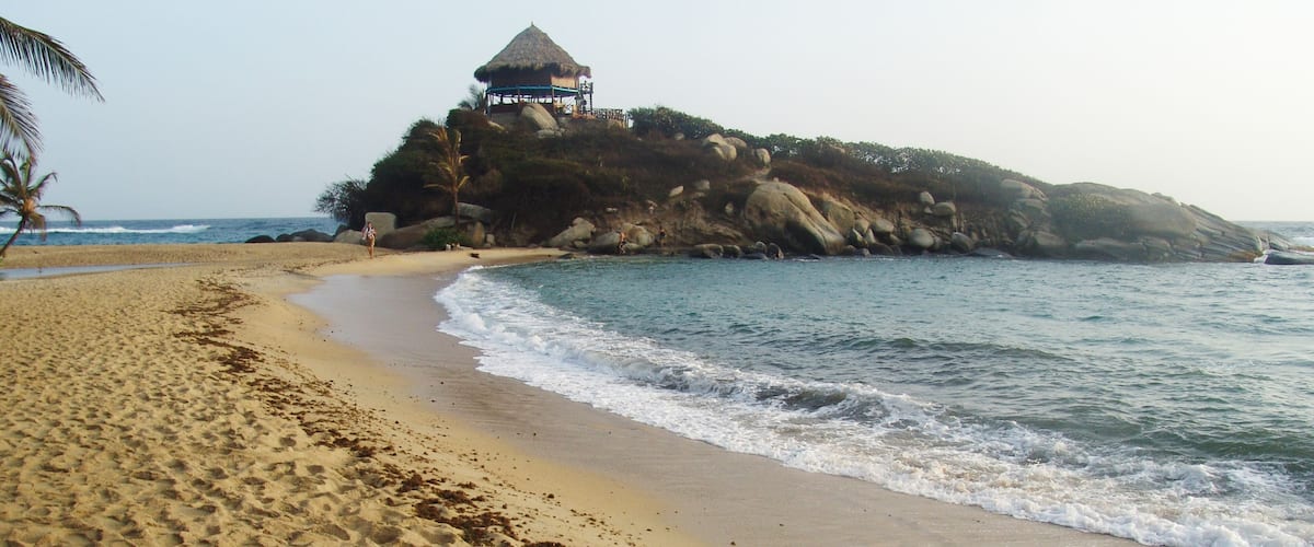 Tayrona National Natural Park showing a beach, general coastal views and a sunset