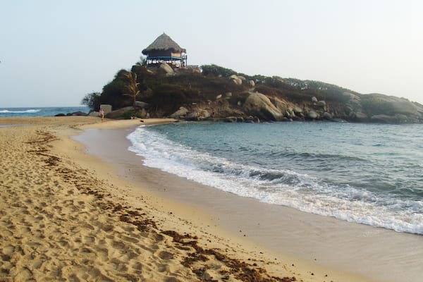 Tayrona National Natural Park showing a beach, general coastal views and a sunset