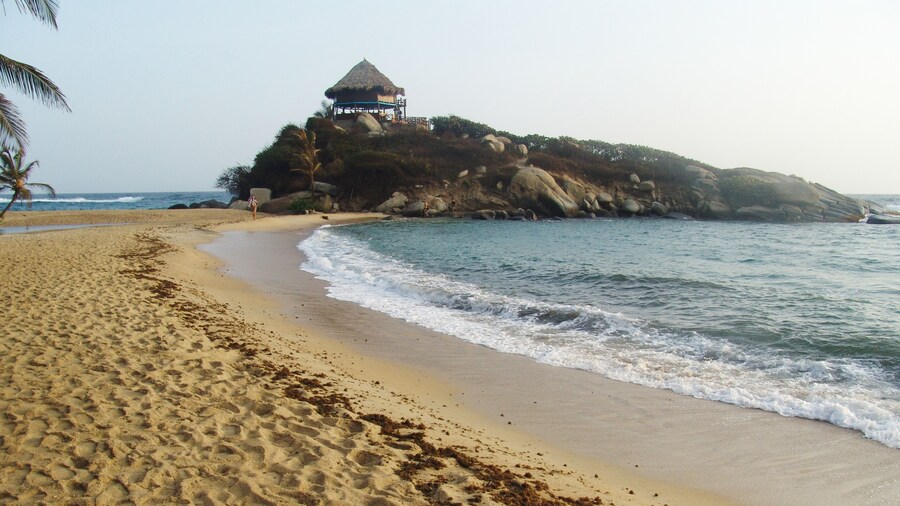 Tayrona National Natural Park showing a beach, general coastal views and a sunset