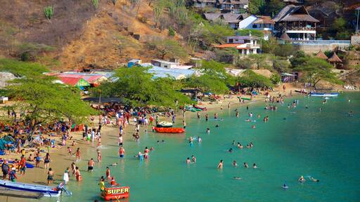 Taganga Beach showing swimming, a sandy beach and a coastal town